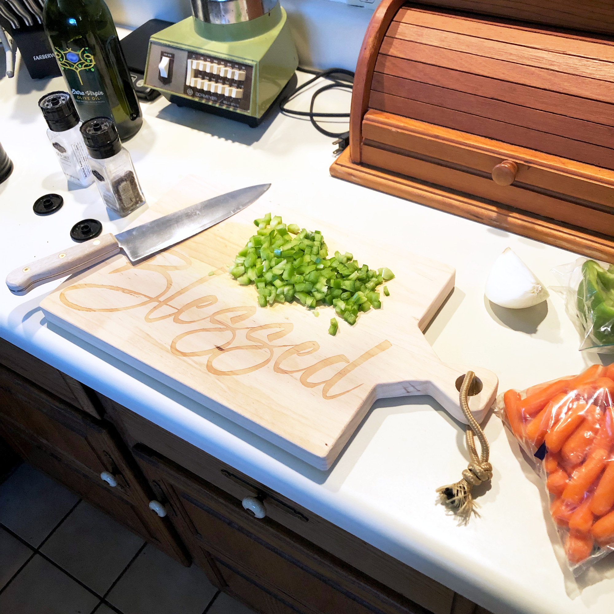 Blessed Cutting Board, a Knife and Chopped Vegetables